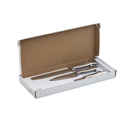 Coffret ouvert contenant trois couteaux en acier inoxydable de tailles différentes, maintenus dans un insert blanc.