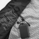 Vue détaillée de l'intérieur du gilet chauffant ouvert, montrant la doublure à motif hexagonal, l'étiquette d'entretien et une b Vue détaillée de l'intérieur du gilet chauffant ouvert, montrant la doublure à motif hexagonal, l'étiquette d'entretien et une b