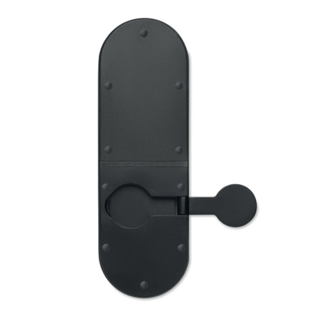 Vue du dessous de la station de recharge noire repliée, montrant ses petits patins antidérapants et son chargeur circulaire laté