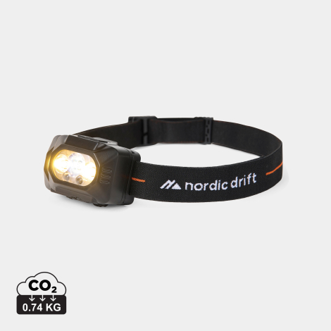 Lampe frontale noire présentée de trois quarts, avec ses LED allumées et son bandeau réglable formant une boucle. Un pictogramme