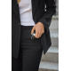 Une femme vêtue d'un tailleur noir et d'un haut blanc tient une alarme d'urgence noire dans sa main, avec la lampe circulaire al Une femme vêtue d'un tailleur noir et d'un haut blanc tient une alarme d'urgence noire dans sa main, avec la lampe circulaire al