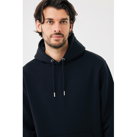 Portrait d'un homme aux cheveux bruns portant un sweat à capuche bleu marine, avec cordons de serrage assortis, œillets métalliq